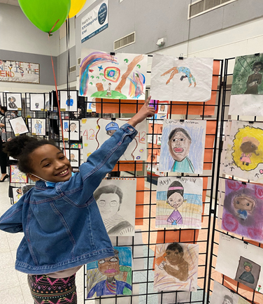 student artist showing her work